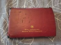 Worn maroon presentation case front with gold Royal Canadian Mint text