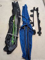 Two ski bags opened showing skis, poles and pair of snap racks