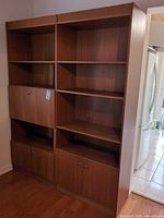 Front view of full bookcase showing shelves and cabinets