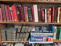 Upper shelf assorted fiction and non-fiction, grey hardcover set, large format reference books