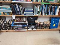 Two bottom shelves filled with assorted books