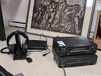 Group shot of Samsung Blu-ray player, Sharp and Panasonic VCRs, Sony headset on stand