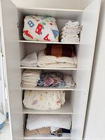 Full cupboard view showing variety of linens and fabrics