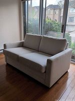 Front angled view of loveseat showing overall style and cushions