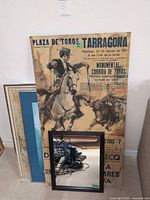 Poster, framed map, mirror and empty frame stacked