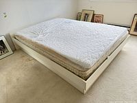 overall view of white platform bed with mattress
