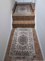 Two small matching rugs laid on stairs