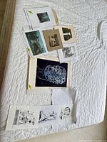 Overview of all prints laid out on bed