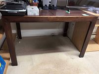 Full view of rectangular dark wood table with items on top