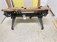 Front view of folded metal frame workbench with wood jaws