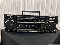 Front view of Fisher PH-W804 boombox showing dual cassette decks, tuner, speakers and handle