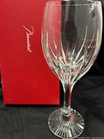 full view of Baccarat cut crystal wine glass in front of red branded box