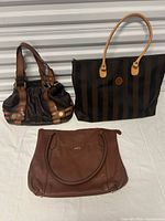 Three handbags arranged for overview