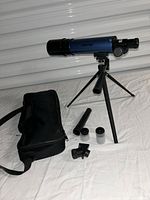 Telescope assembled on tripod with bag and accessories visible