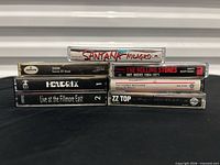 Front view of all seven cassette spines showing titles and artists