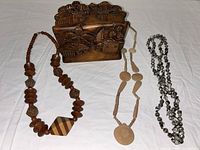 box and three necklaces laid out