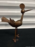 Front left view of copper roadrunner figurine