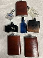 Group shot of all three flasks and five cologne bottles on white background
