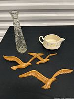 Overall lot showing four wall birds, bud vase, creamer