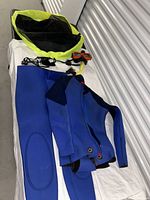 Wetsuit pieces and mesh gear bag laid out