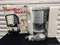 Machine with damaged box and styrofoam packaging