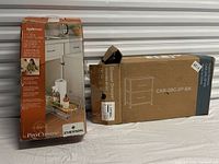 Both boxed items: ClosetMaid tray slider and two-drawer dresser