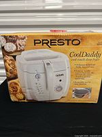 Front of sealed retail box showing Presto CoolDaddy deep fryer image