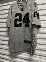 Front view of grey Raiders #24 jersey on hanger