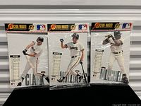 Front view of three sealed San Francisco Giants stand-up figures