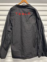 Back view showing red Tesla embroidery
