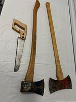 Overall shot showing two axes and hand saw
