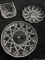 Three glass items: square bowl, egg plate, round platter