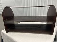 Front view of two-tier wooden shoe rack showing shelves and frame