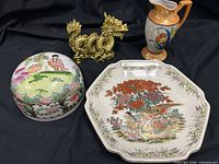 Group shot of octagon plate, Nippon bowl with lid, floral pitcher, gold dragon figurine