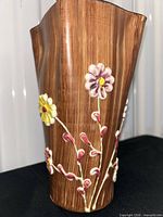 Front view showing brown wood-grain glaze and applied yellow and pink flowers
