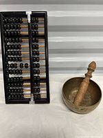 Singing bowl, striker and abacus together