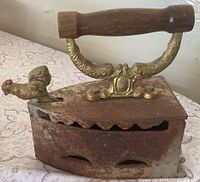 Left side view showing brass rooster latch, handle, rusted body