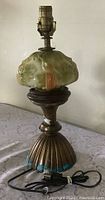 Full view of the antique electric oil lamp with cord visible
