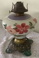 Full view of oil lamp showing porcelain font, burner, and metal base