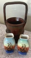 Front view of Emerson stoneware basket with two Noritake vases