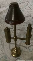 Full view of brass dollhouse lamp showing shade, stem, side cylinders and base