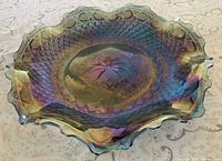 Top view of iridescent carnival glass dish showing diamond point pattern and scalloped edge