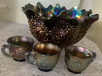 Punch bowl front with three cups showing iridescent blue and Orange Tree relief