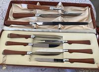 Open case showing all cutlery pieces in two tiers