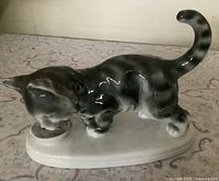 Front view of porcelain cat figurine on base