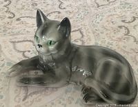 Front view of gray tabby cat figurine