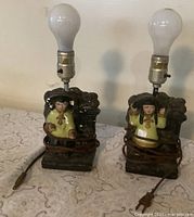 Front view of both chalkware lamps with bulbs attached