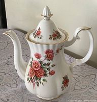Front view of Centennial Rose coffee pot with lid showing floral pattern and gold trim