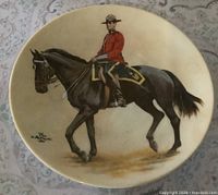 Front view of plate showing RCMP officer on horseback illustration