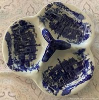Top view showing three sections, flow blue pattern, central handle